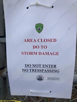 May be an image of text that says "AREA CLOSED DO TO STORM DAMAGE DO NOT ENTER NO TRESSP SPASING S"